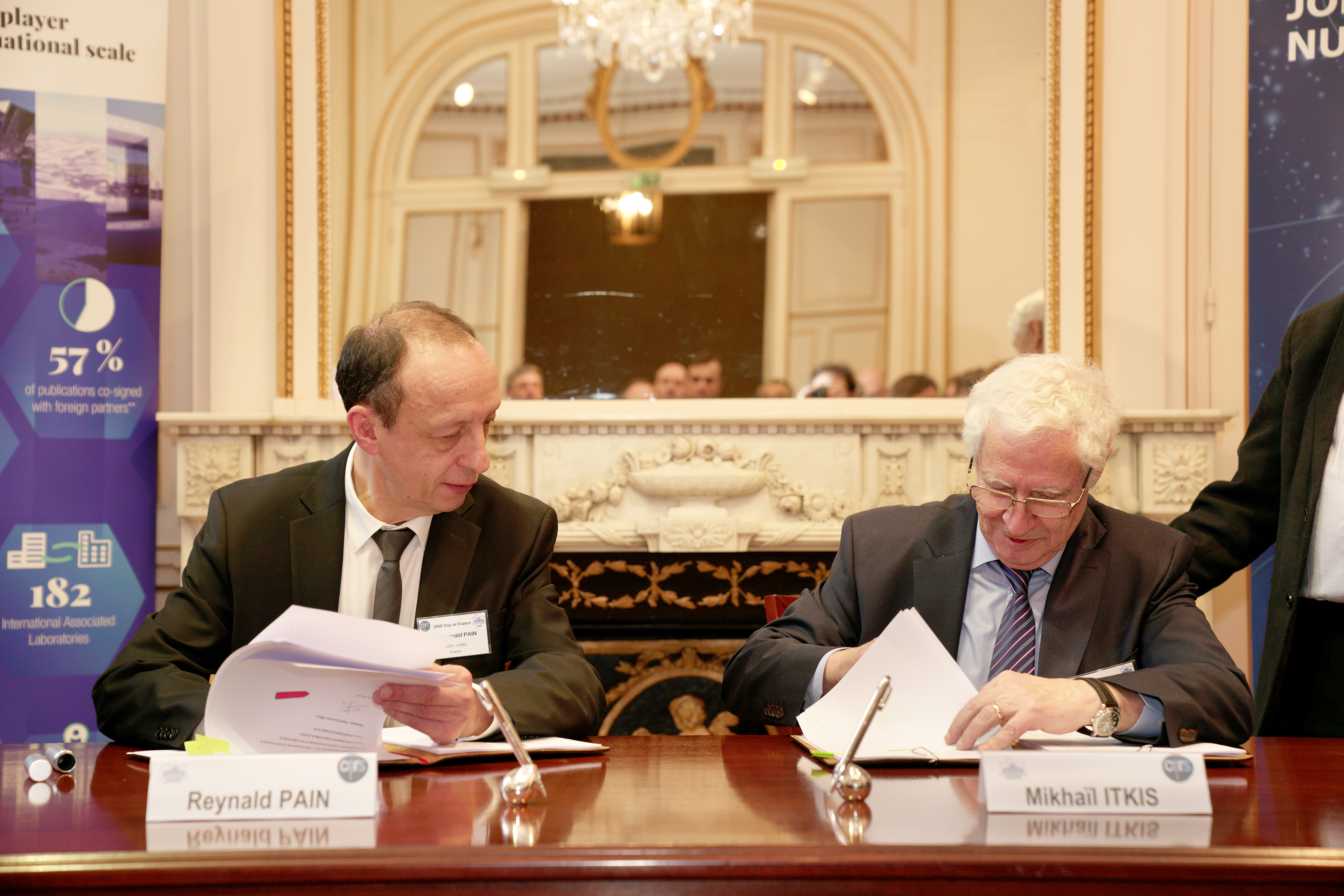 Reynald Pain et Mikhail Itkis assis à un bureau signe des documents.