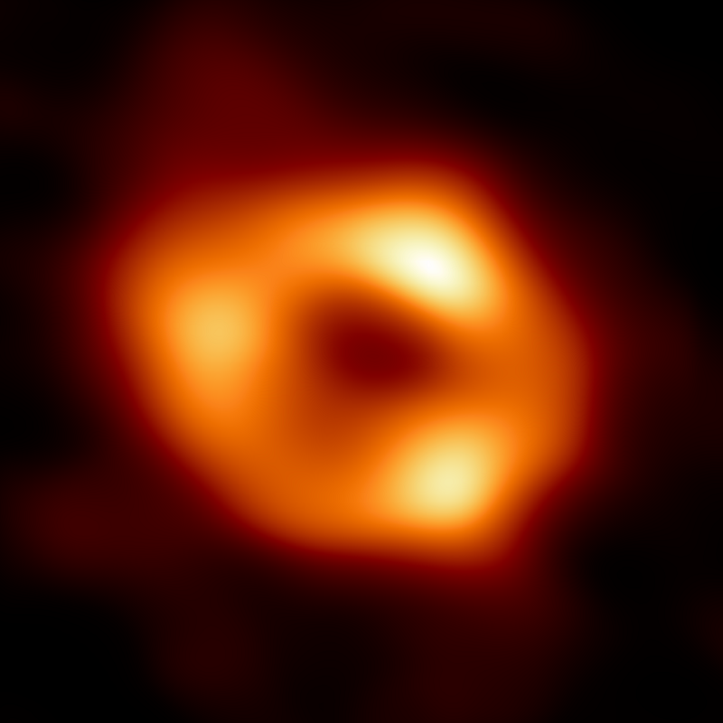 donut-like structure that reveals the shadow of the black hole in the center.  The image is blurred because it is the average of several different images.